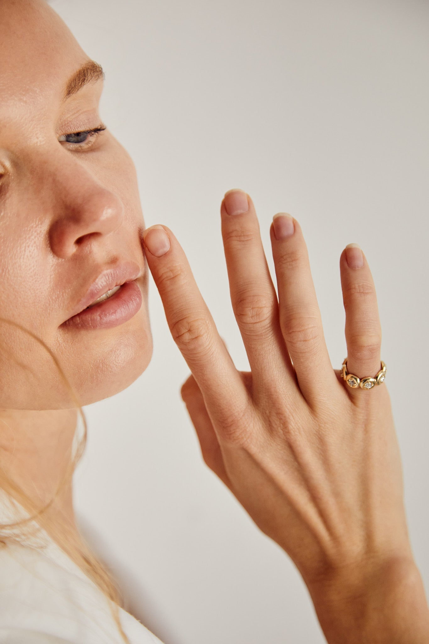 Woman wearing 9ct gold rings with minimalist design — Thor Collective rings collection.