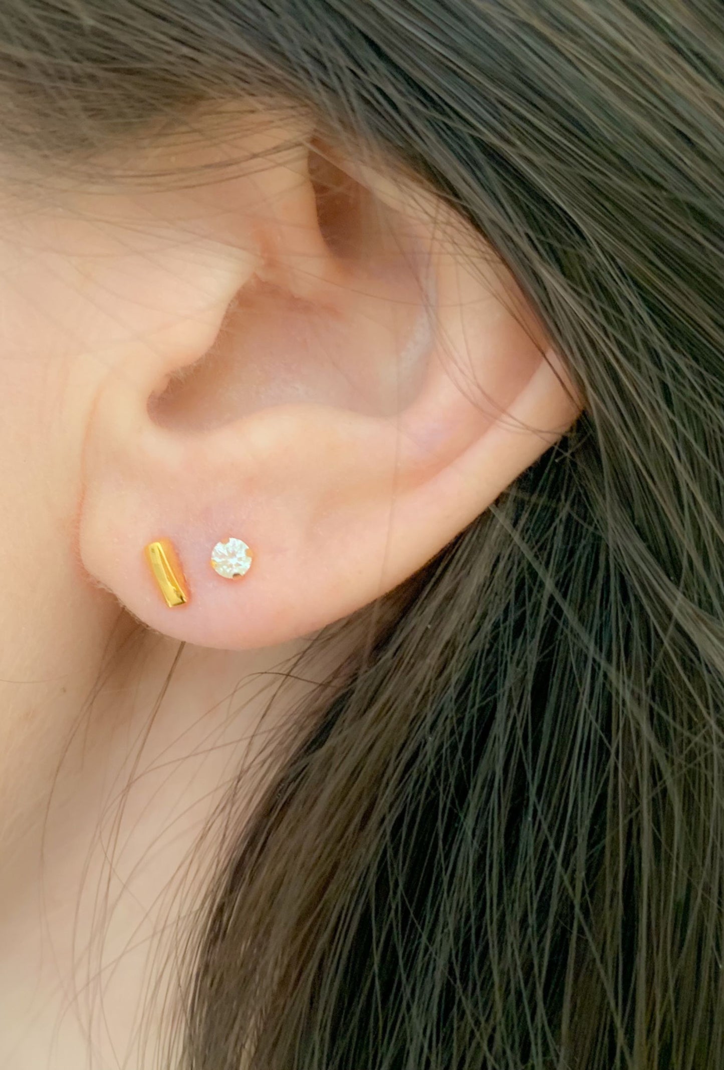 yellow gold diamond stud earrings and yellow gold linear bar stud earrings