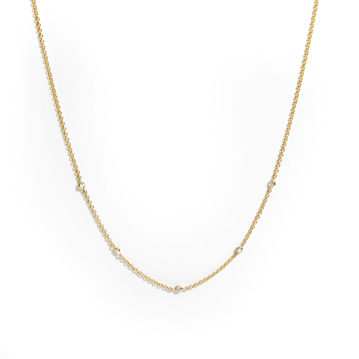 Natural diamond station necklace in 9ct yellow gold with five diamonds spaced along a fine chain