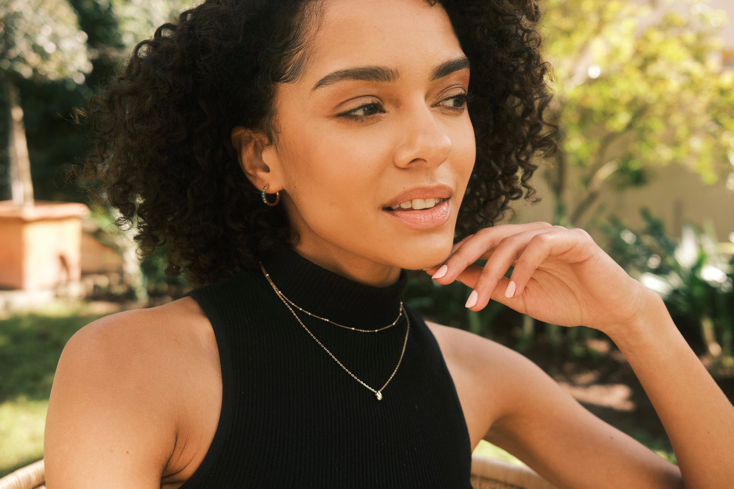 woman earing 9ct yellow gold necklaces and hoops by Thor Collective