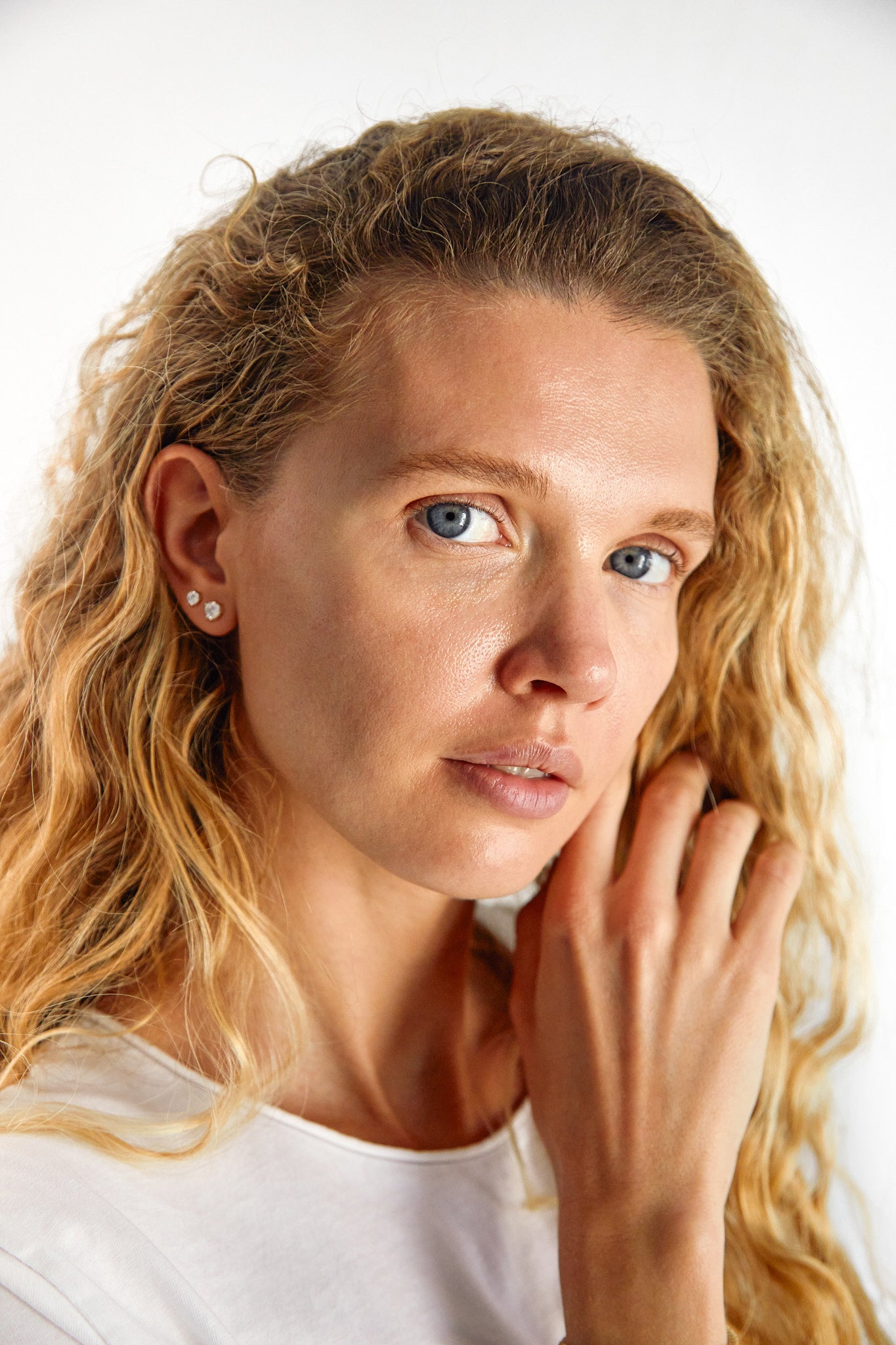 woman wearing 9ct gold lab-grown diamond studs,