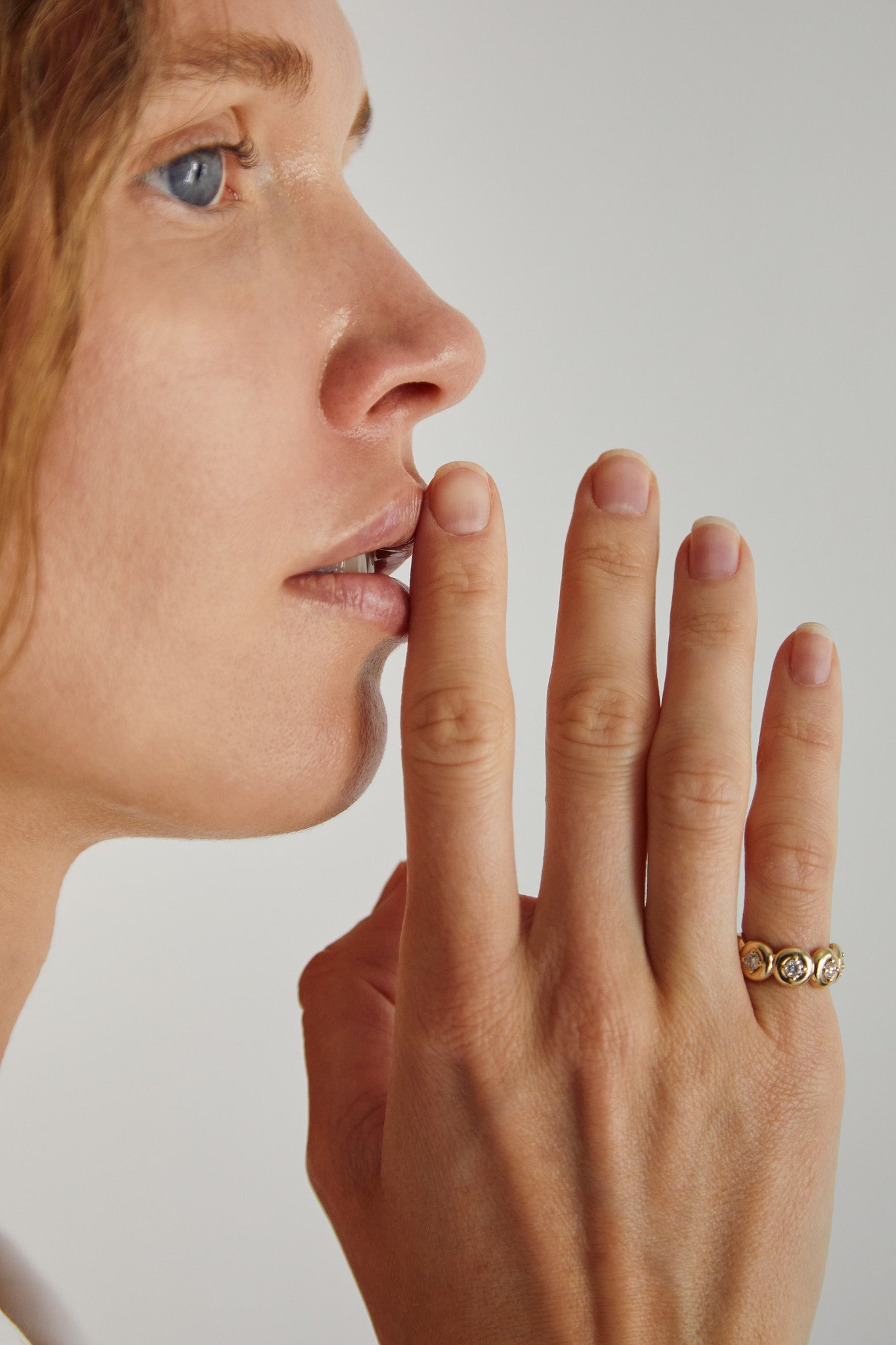 Close-up of model wearing a 9ct gold bezel diamond ring