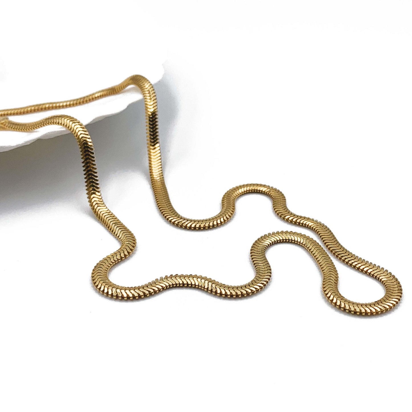 Gold snake chain necklace by Thor Collective