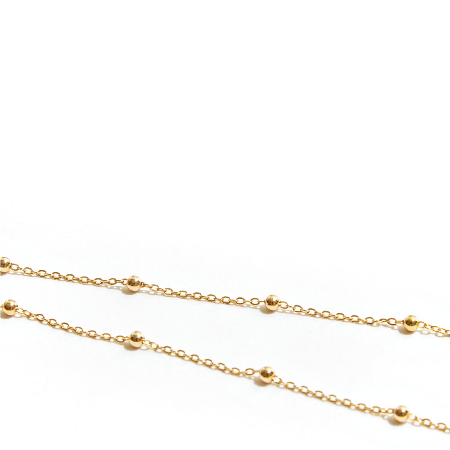 Close-up detail of polished bead accents on fine 9ct gold chain