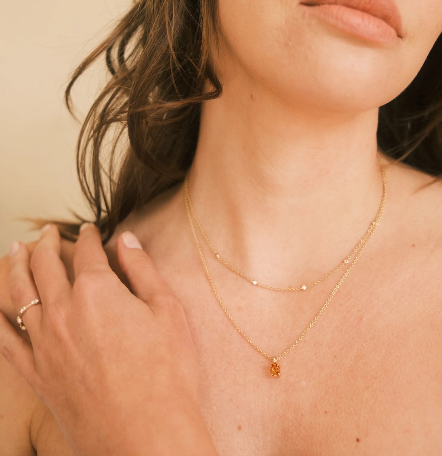 woman wearing solid gold necklaces and ring by thor collective