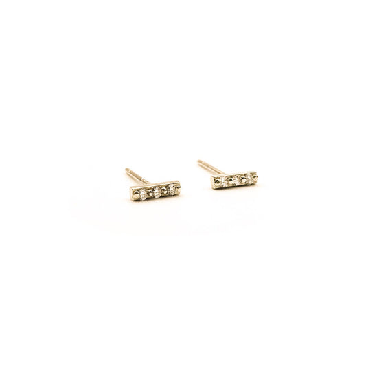 trio of white diamonds in 9ct gold stud earrings  