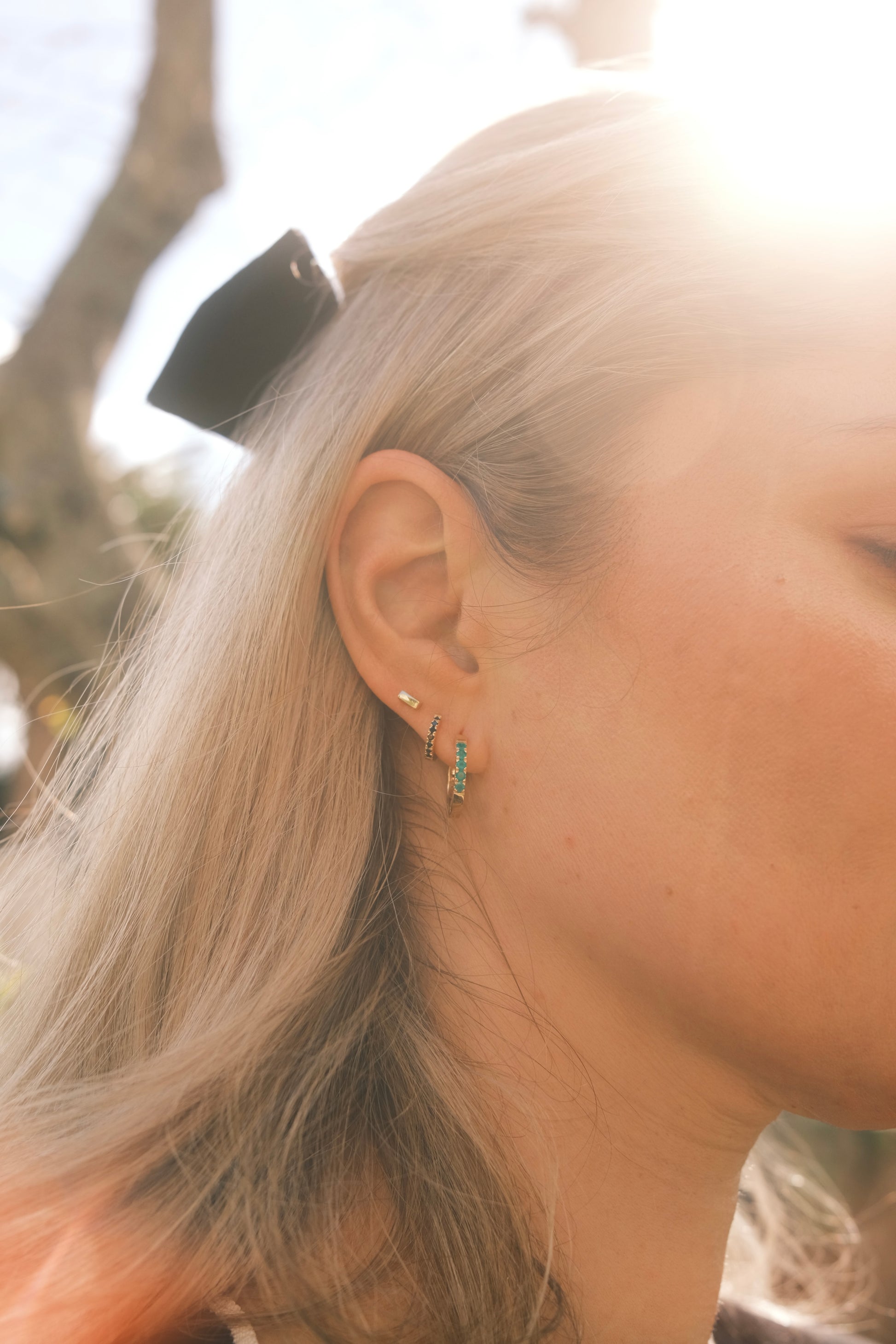 Minimalist 9ct gold bar stud earrings worn in curated ear stack