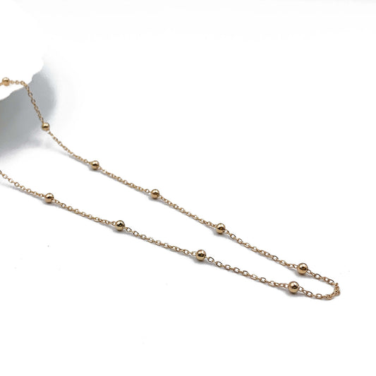 9ct yellow gold rolo bead necklace laid flat showing evenly spaced polished beads