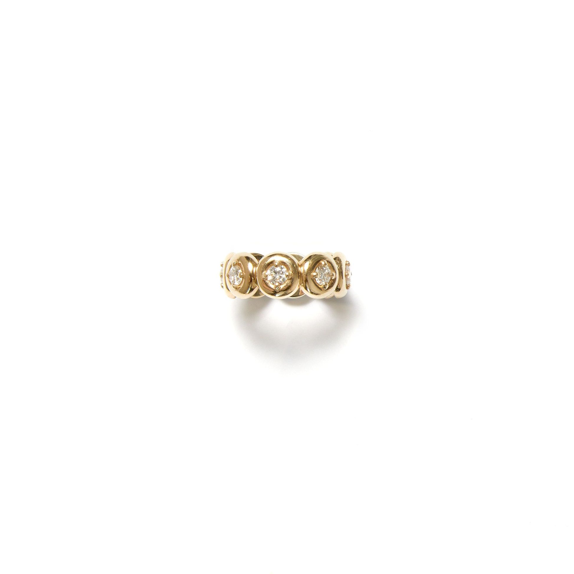 Yellow gold lab grown diamond bezel eternity ring on white background