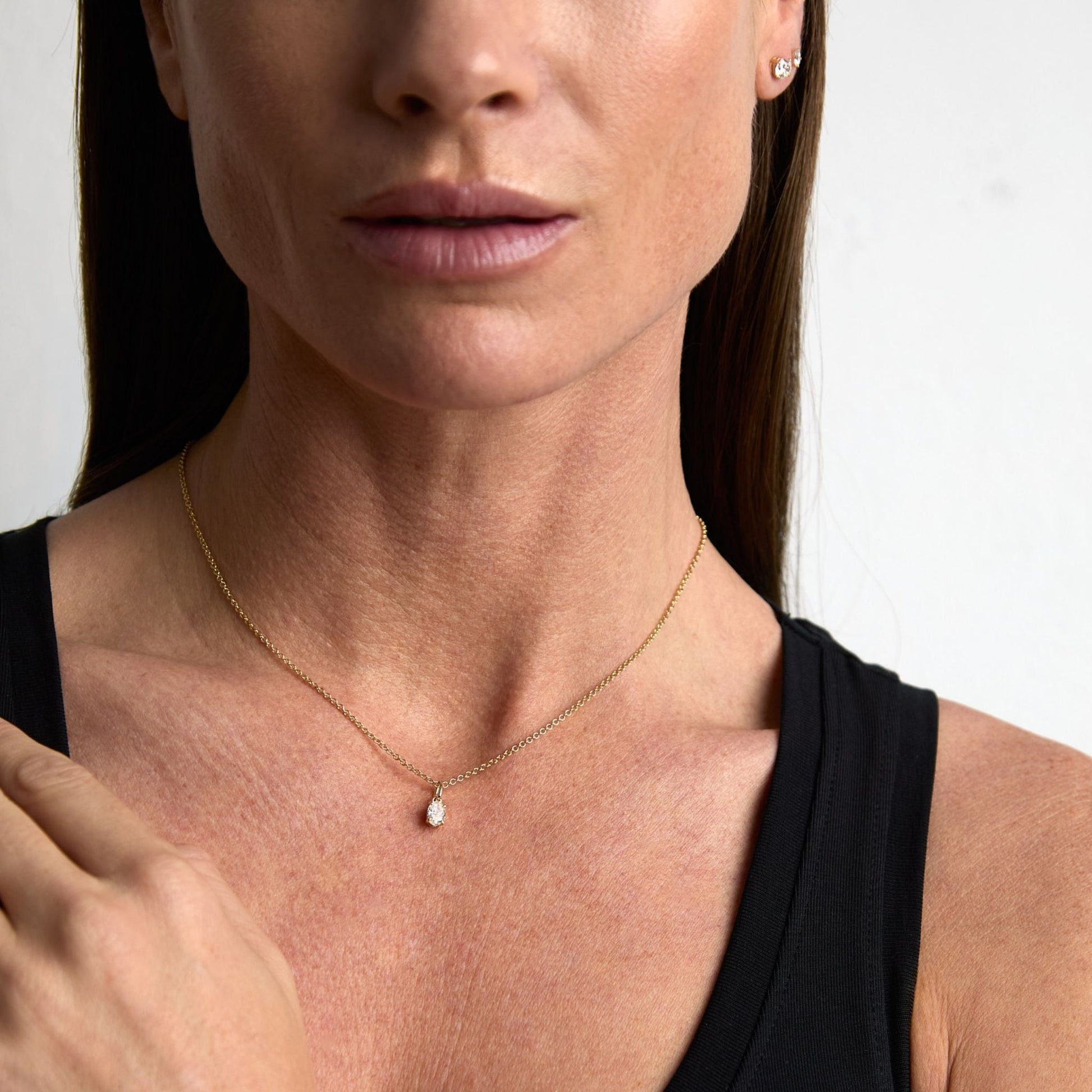 Oval lab grown diamond pendant necklace worn in 9ct yellow gold