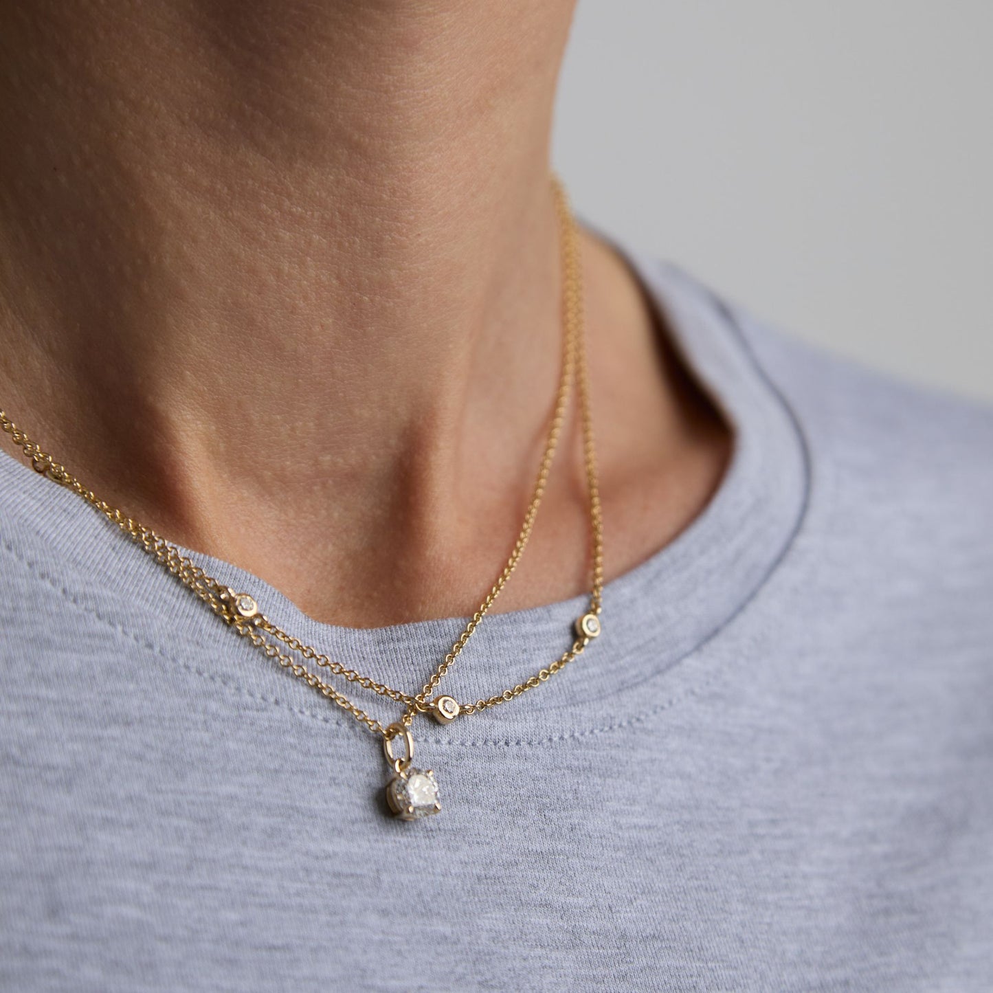 Round lab grown diamond pendant layered with gold necklaces in 9ct yellow gold