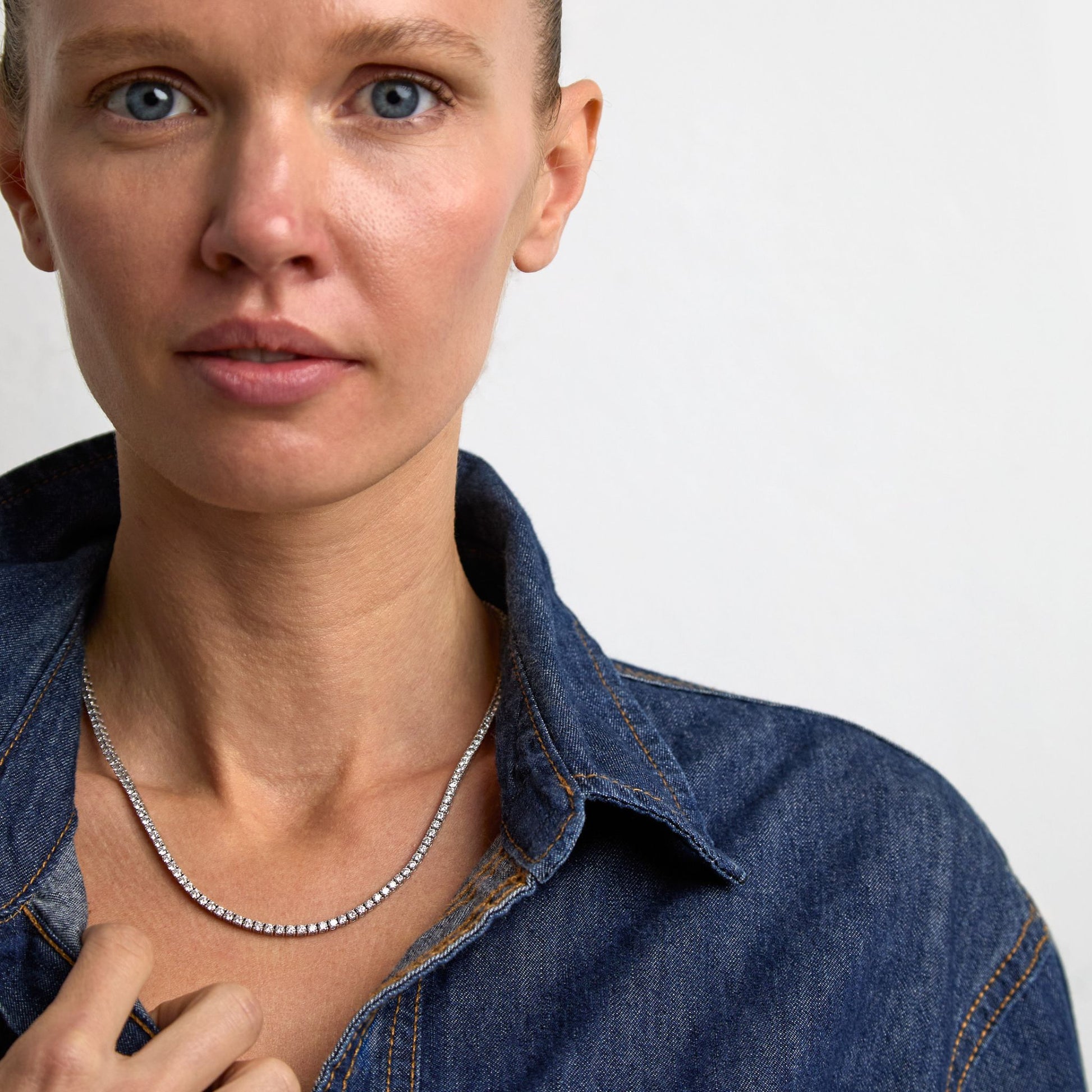Fine lab grown diamond tennis necklace in white gold styled on model