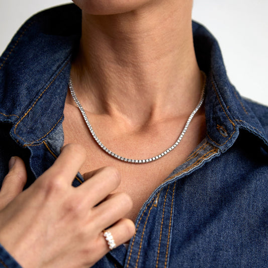 Model wearing a lab grown diamond tennis necklace in solid gold by Thor Collective