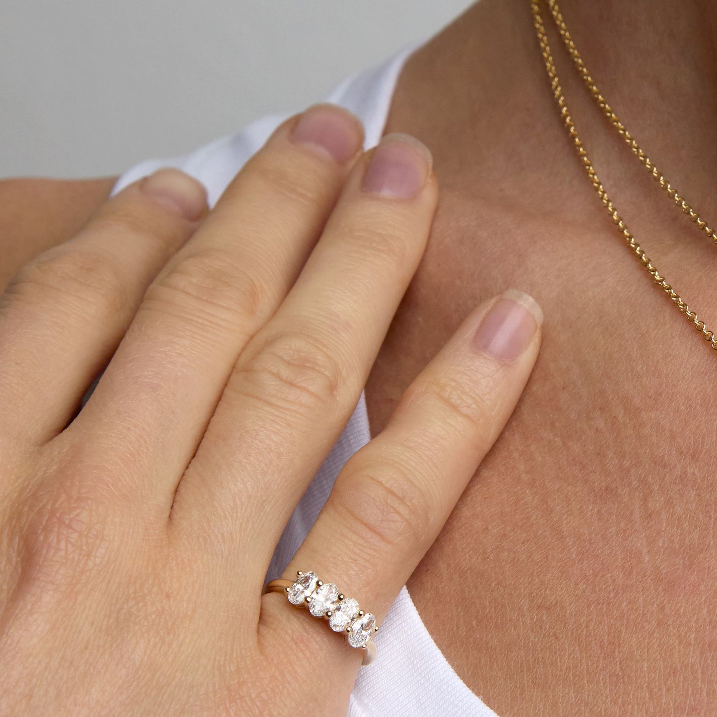 Oval lab grown diamond ring worn on hand in 9ct yellow gold