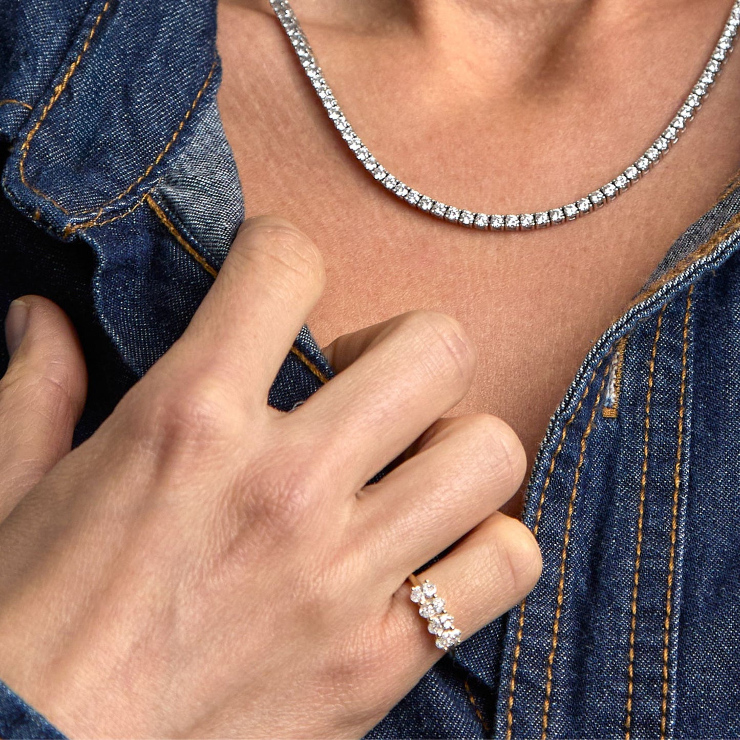 Oval lab grown diamond ring styled with a diamond tennis necklace