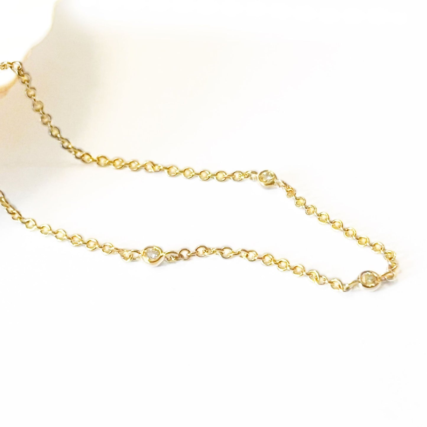 Natural diamond station bracelet in 9ct yellow gold on white background