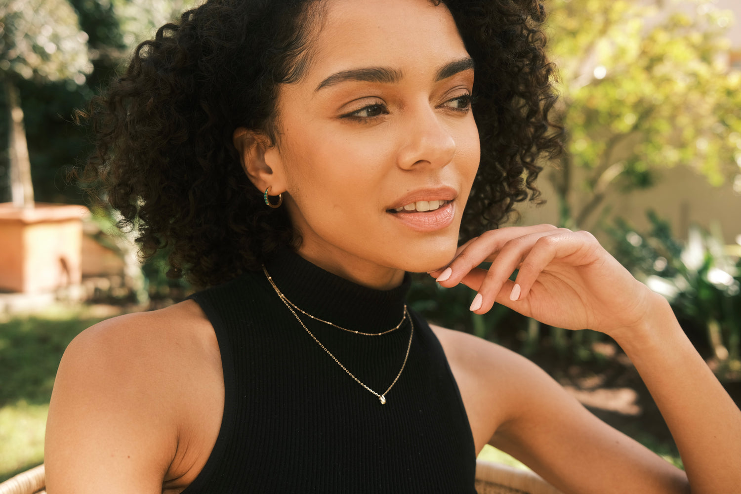 woman earing 9ct yellow gold necklaces and hoops by Thor Collective 