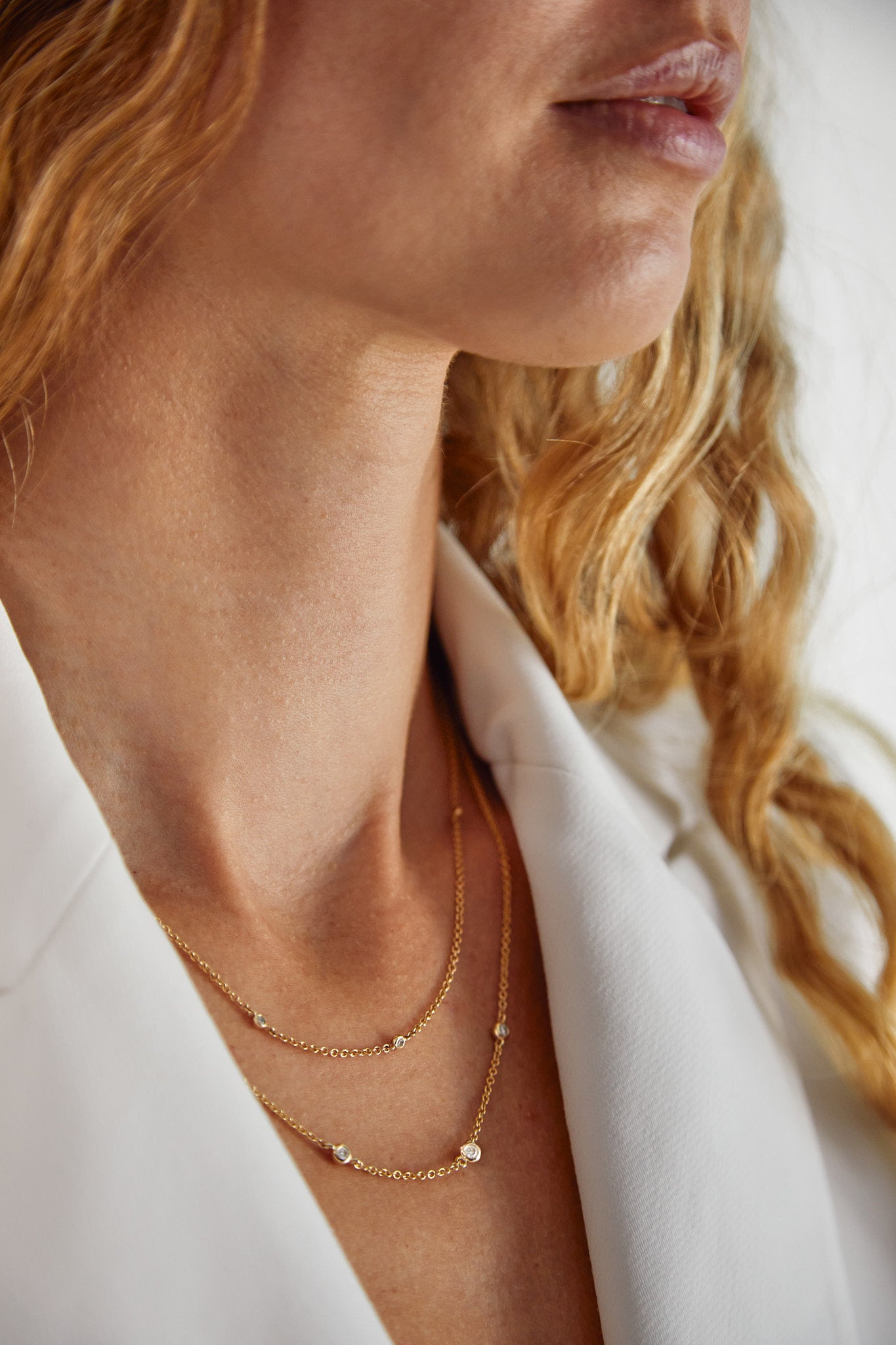 Close-up of woman wearing 9ct gold necklace in soft sunlight — Thor Collective jewellery brand South Africa.