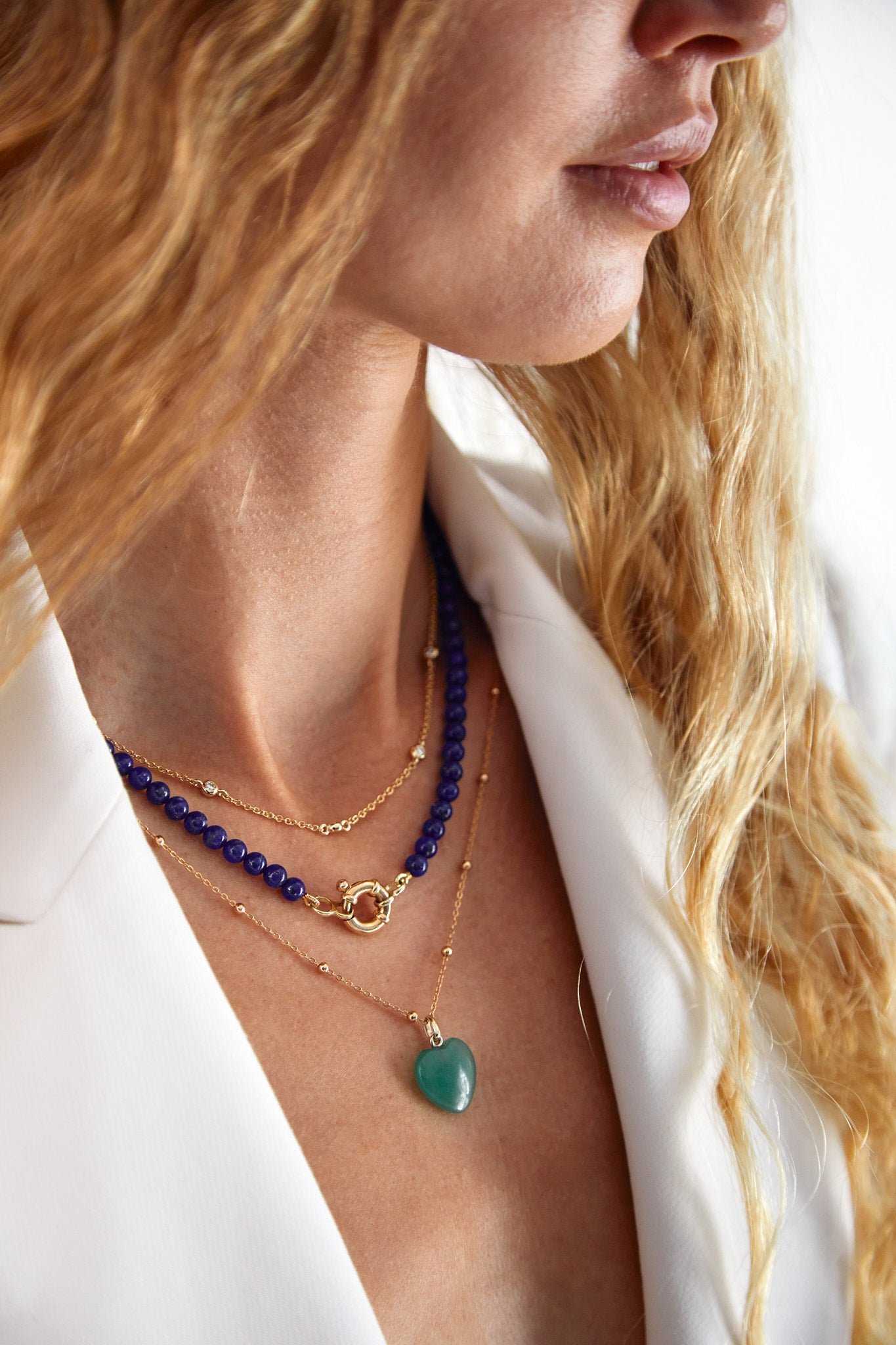Side profile of model wearing deep blue lapis lazuli beaded necklace with gold clasp — elegant gemstone jewellery.