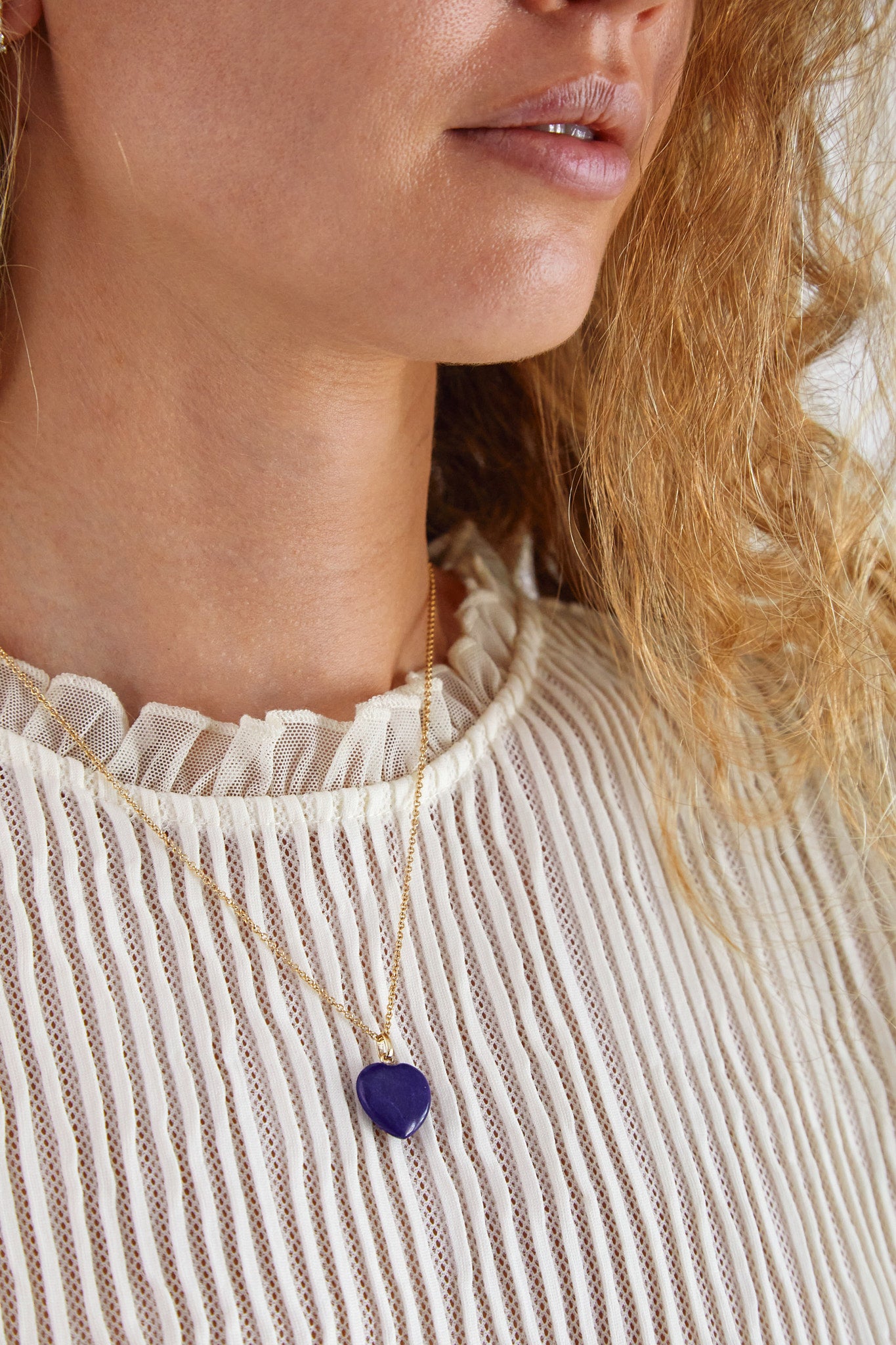 Model wearing 9ct gold lapis lazuli heart pendant — modern heirloom jewellery with a touch of colour and sentiment.