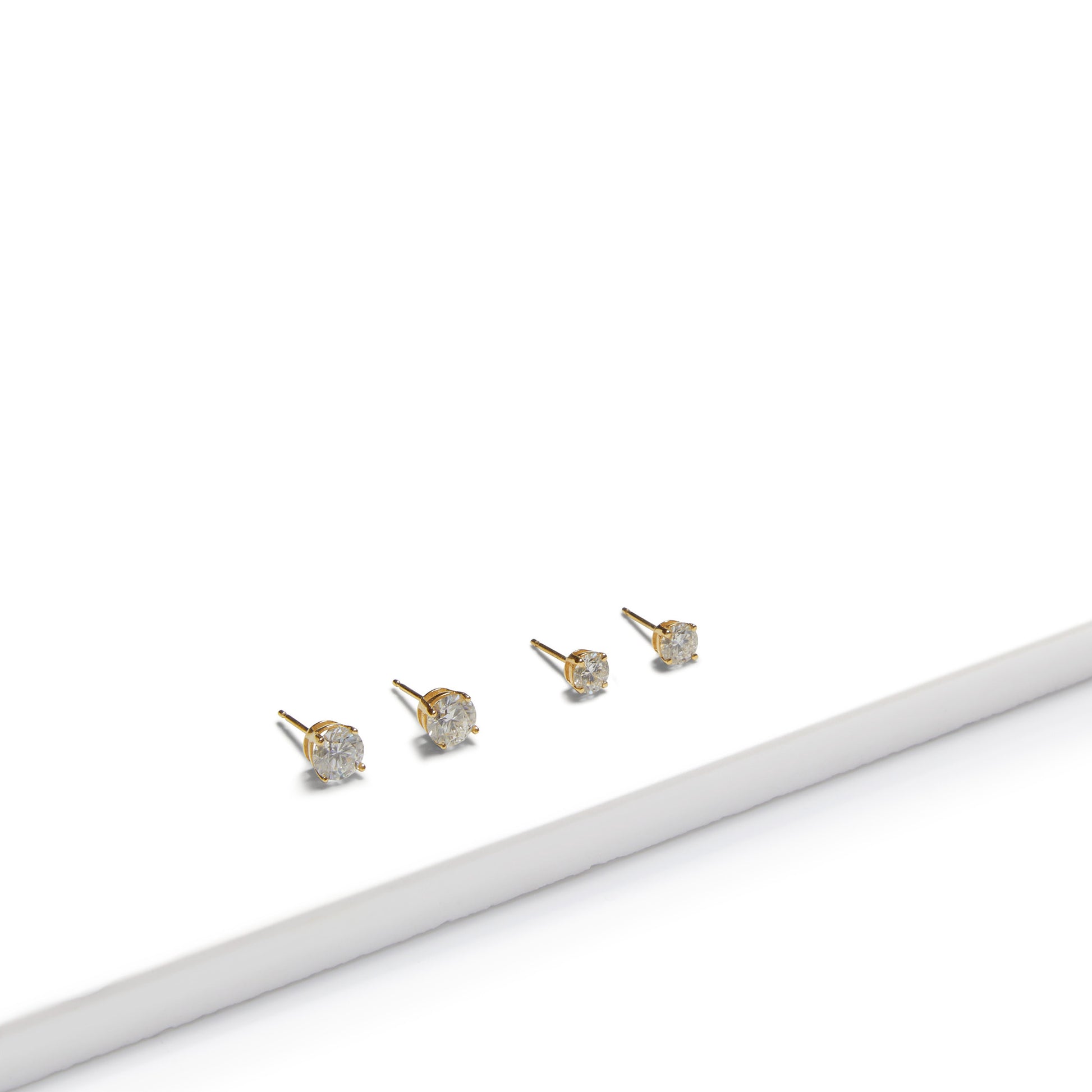 Four 9ct gold lab-grown diamond stud earrings displayed on a white background, showcasing classic fine jewellery design by Thor Collective.